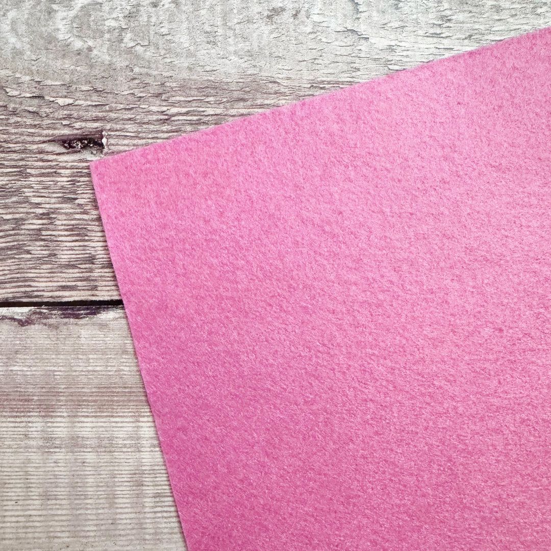 Pink felt sheet on a wooden surface
